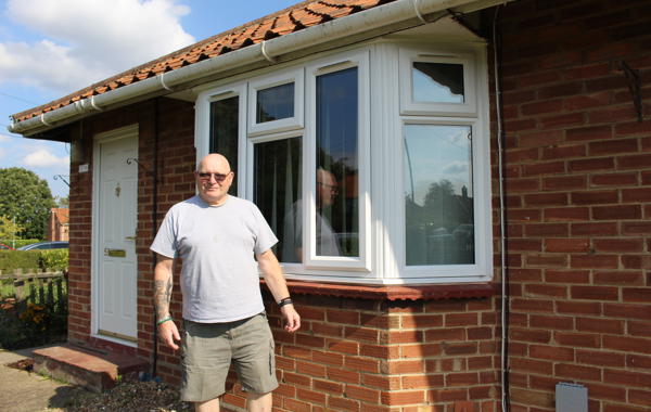 Saffron Tenant Standing Outside His House