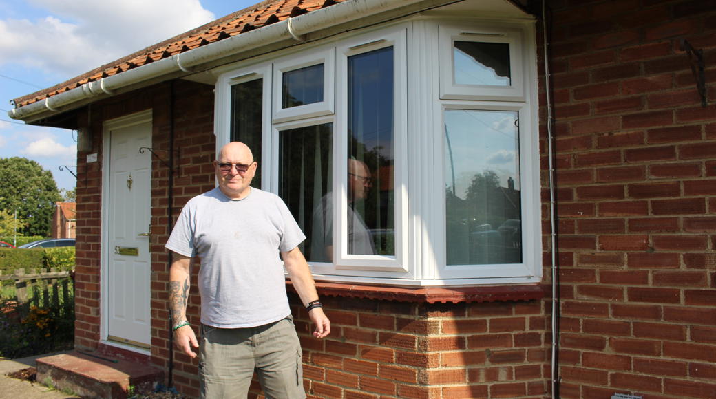 Saffron Tenant Standing Outside His House