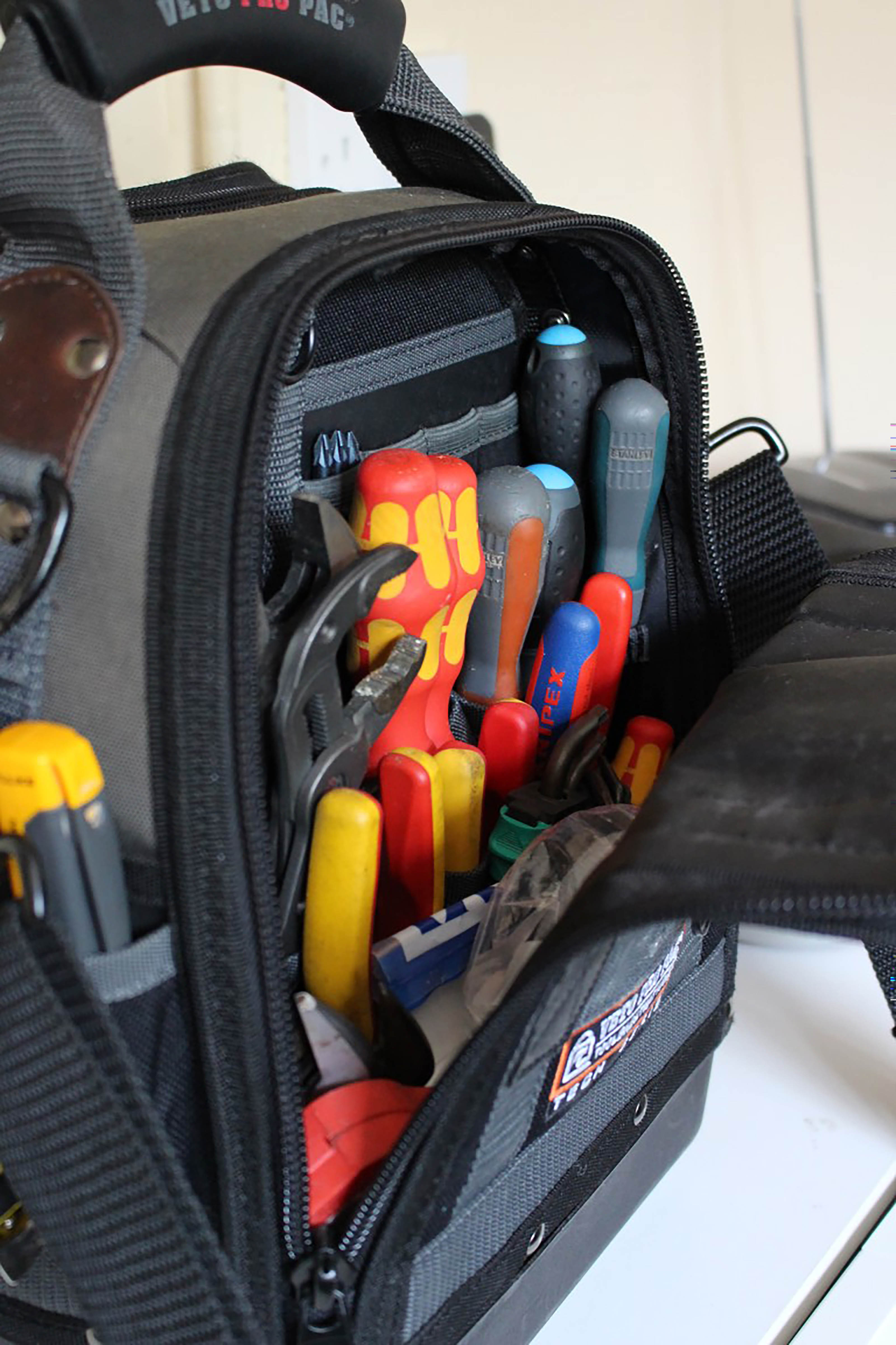 A Bag Of Work Tools Including Spanners And Screwdrivers