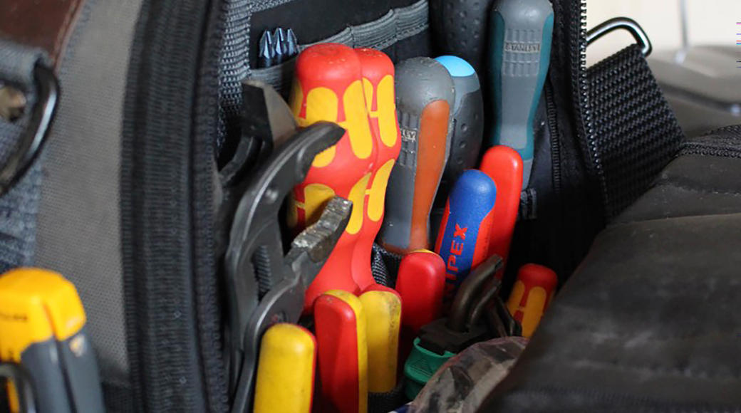 A Bag Of Work Tools Including Spanners And Screwdrivers