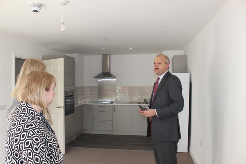 Local MP Standing In Kitchen Talking To Saffron Staff