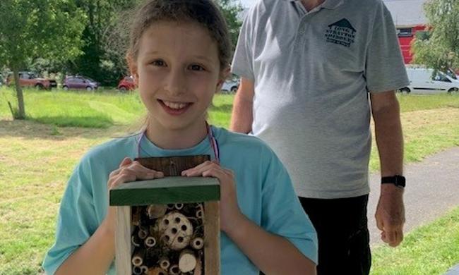 Child And Man Posing With Bug Hotel