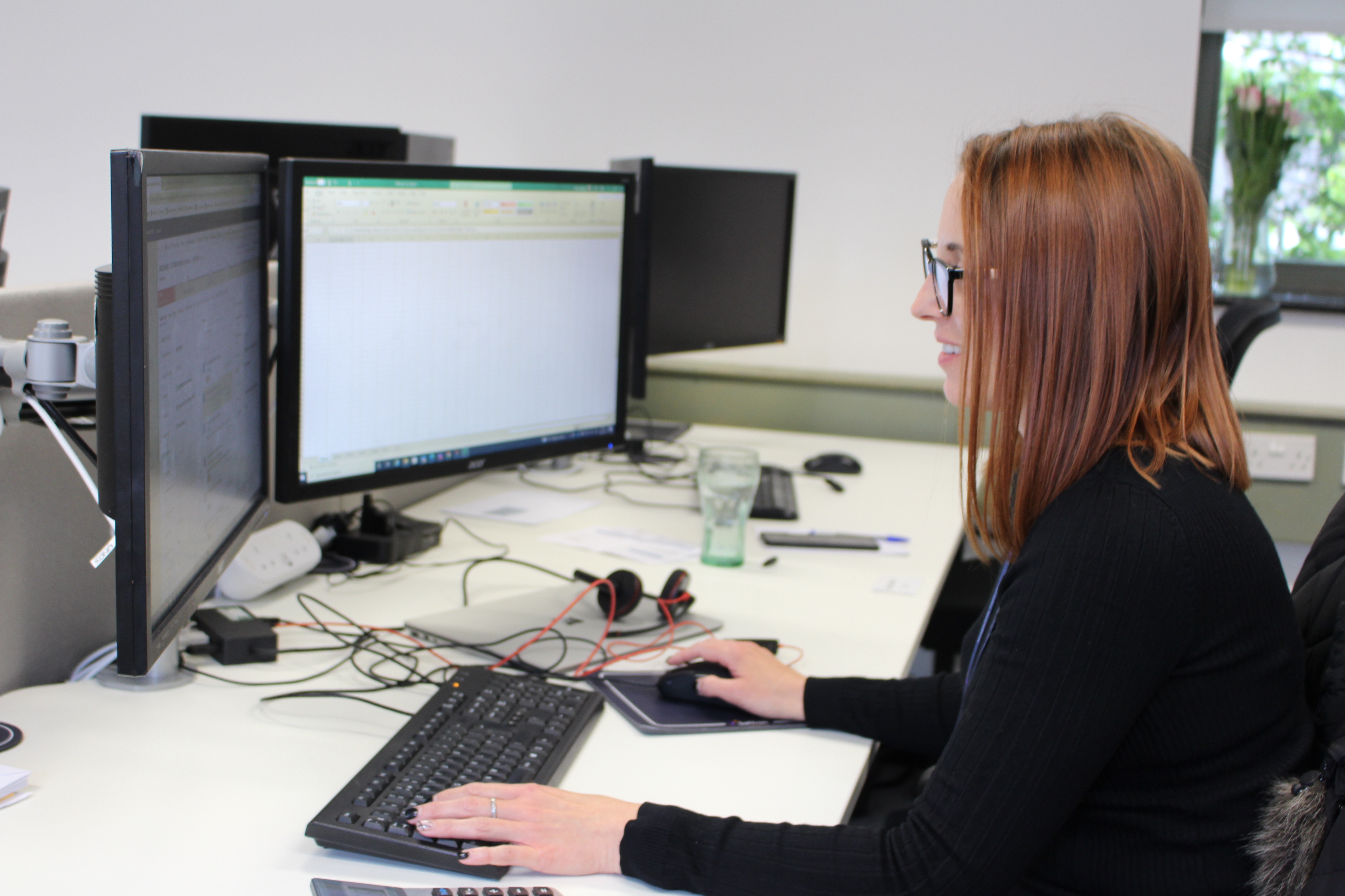 Worker At Desk On Headset