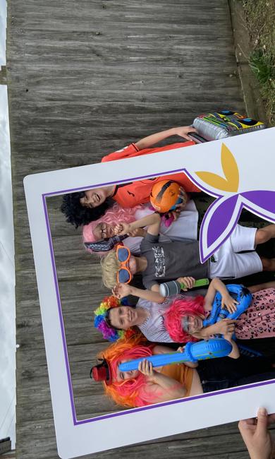 Children Posing Behind Saffron Photo Frame