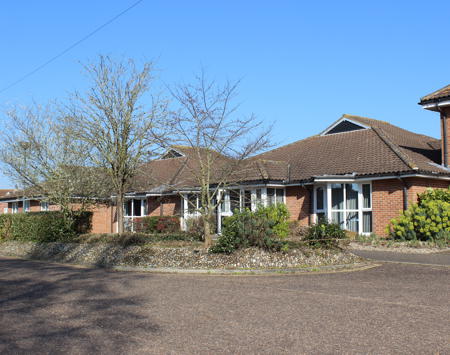 Red Brick Building With Trees In Front