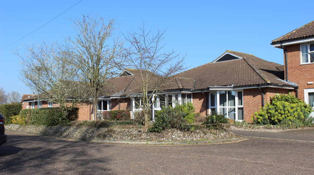 Red Brick Building With Trees In Front