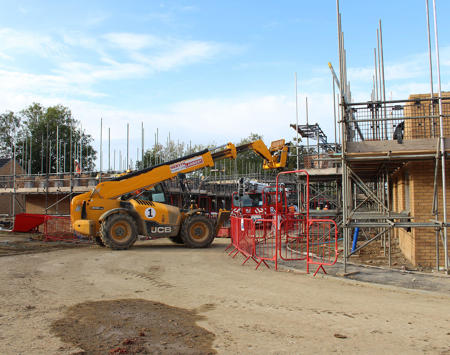Construction Site With Scaffolding And Yellow Fork Lift