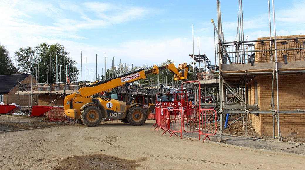 Construction Site With Scaffolding And Yellow Fork Lift
