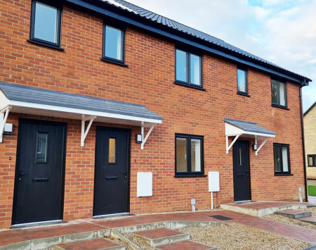 Row Of Brick Houses With Black Doors