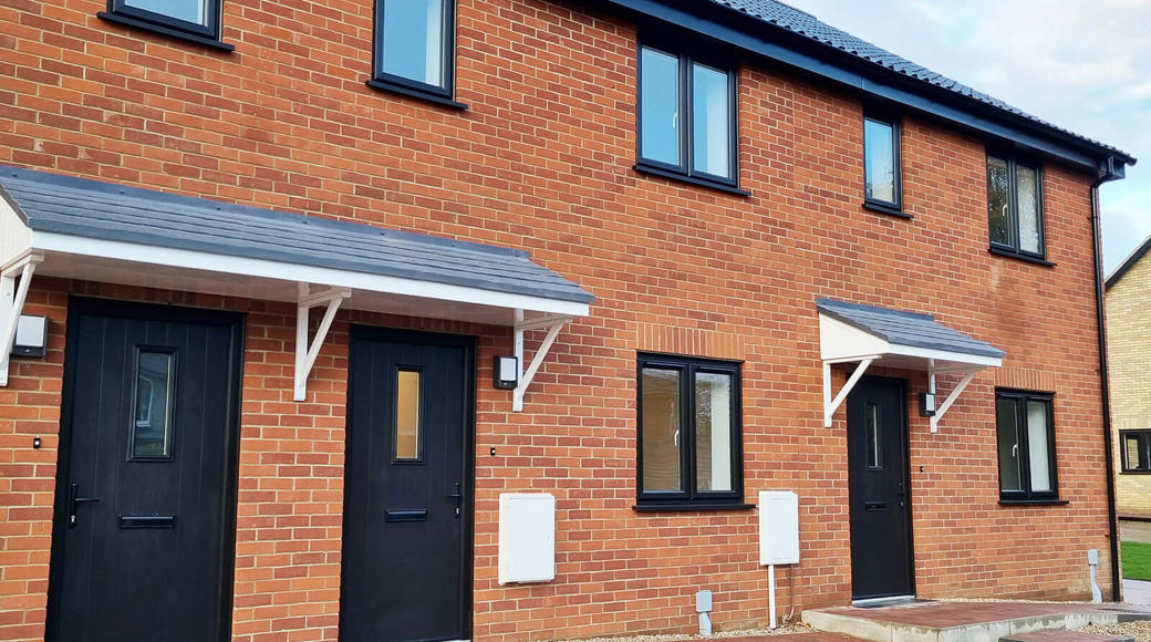 Row Of Brick Houses With Black Doors