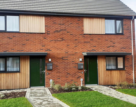 Two Brick Houses With Front Path Up To Dark Green Door